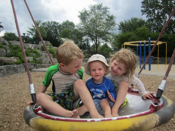 Three kids in a swing